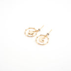 Aretes dorados con sol y luna al centro rodeados de zirconias.