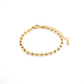 Pulsera en acero inoxidable con baño de oro con esferas