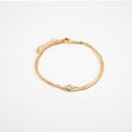 Pulsera dorada con doble cadena y un cristal